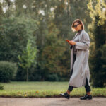 Woman walking through a park in British Columbia, symbolizing local charities promoting mental health and outdoor wellness.