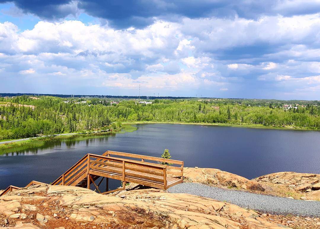 Overlook of a lake and forest landscape in Manitoba symbolizing healing, reflection, and community rooted care