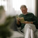 Older man sitting comfortably in a furnished apartment, representing successful housing support from a Montreal homeless shelte