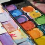 Watercolor paint palette with vibrant colours used in youth art therapy sessions